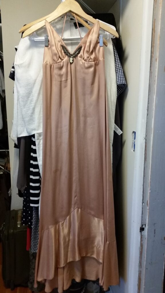 Flesh-colored satin evening gown, bias cut with spaghetti straps, beading and cameo