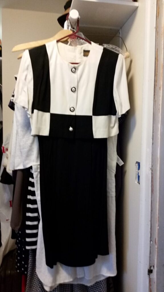 Graphic black and white short sleeved dress with pseudo jacket and big pearl buttons