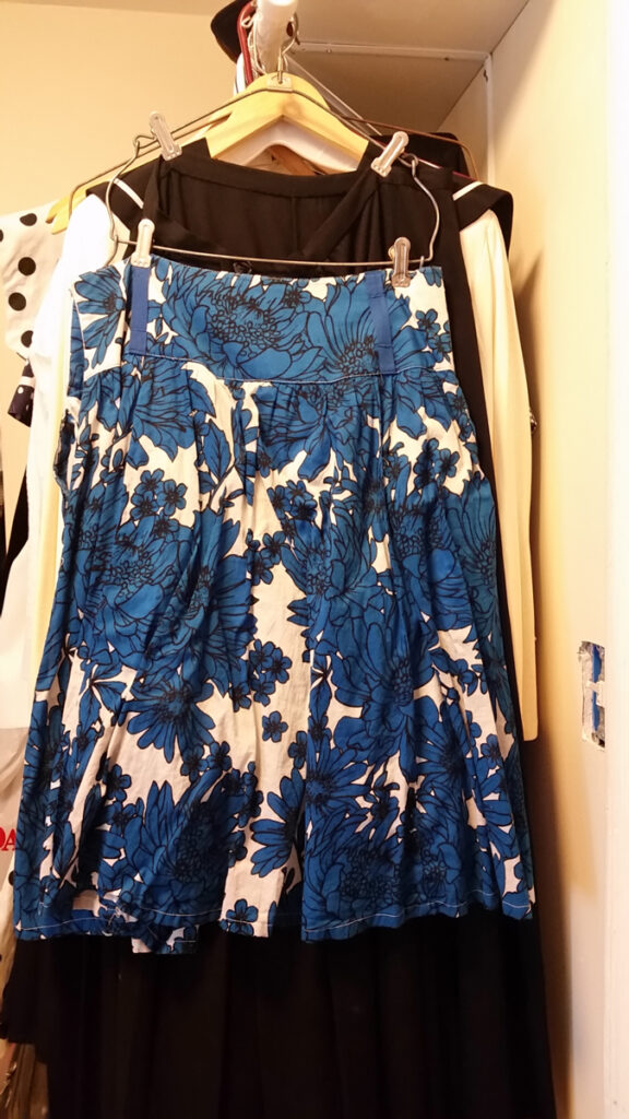 White skirt with big blue and black floral print.