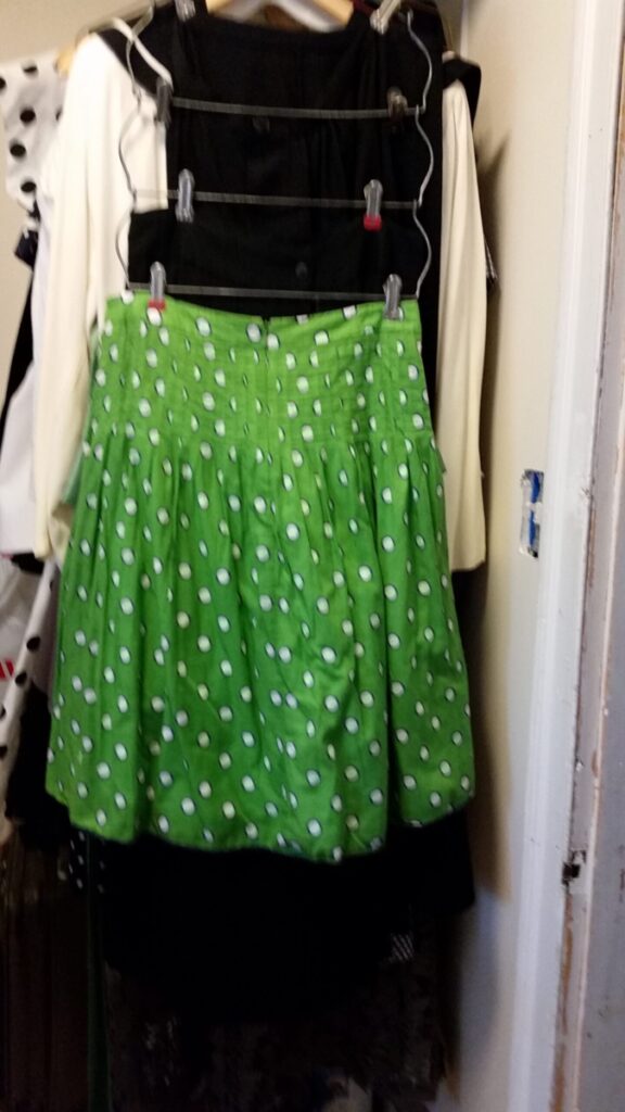 Green skirt with navy-ringed white polka dots